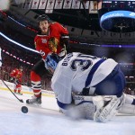 Tampa Bay Lightning goalie Ben Bishop, right, deflects a shot from Chicago Blackhawks' Andrew Shaw as Lightnings' Victor Hedman, left, of Sweden, watches during the second period in Game 6 of the NHL hockey Stanley Cup Final series on Monday, June 15, 2015, in Chicago. (Bruce Bennett/Pool Photo via AP)

