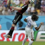 Germany's Benedikt Hoewedes heads the ball over United States' Jermaine Jones during the group G World Cup soccer match between the United States and Germany at the Arena Pernambuco in Recife, Brazil, Thursday, June 26, 2014. (AP Photo/Julio Cortez)
