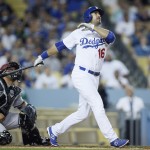 Los Angeles Dodgers' Andre Ethier hits a three-run home run in front of Arizona Diamondbacks catcher Welington Castillo to score Howie Kendrick and Yasmani Grandal during the fifth inning of a baseball game, Monday, June 8, 2015, in Los Angeles. (AP Photo/Danny Moloshok)
