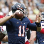 Virginia quarterback Greyson Lambert (11) looks downfield to make a pass during the first half of an NCAA college football game against Louisville in Charlottesville, Va., Saturday, Sept. 13, 2014. (AP Photo/Steve Helber)