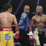 Referee Kenny Bayless separates Manny Pacquiao, from the Philippines, left, and Floyd Mayweather Jr., during their welterweight title fight on Saturday, May 2, 2015 in Las Vegas. (AP Photo/Isaac Brekken)
