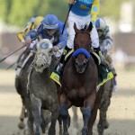 Victor Espinoza rides American Pharoah to victory in the141st running of the Kentucky Derby horse race at Churchill Downs Saturday, May 2, 2015, in Louisville, Ky. (AP Photo/Darron Cummings)