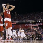 Wisconsin's Frank Kaminsky (44) and Nigel Hayes (10) walk off the court as Duke players celebrate their 68-63 victory over Wisconsin in the NCAA Final Four college basketball tournament championship game Monday, April 6, 2015, in Indianapolis. (AP Photo/Michael Conroy)