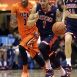 Arizona guard Gabe York, right, races downcourt ahead of Oregon State guard Gary Payton II during the first half of an NCAA college basketball game in Corvallis, Ore., Sunday, Jan. 11, 2015. (AP Photo/Don Ryan)
