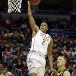 Texas' Demarcus Holland (2) goes up for a basket against Arizona State's Jonathan Gilling (31) during the first half of a second-round game in the NCAA college basketball tournament Thursday, March 20, 2014, in Milwaukee. (AP Photo/Jeffrey Phelps)