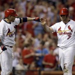 St. Louis Cardinals' Matt Holliday, right, is congratulated by teammate Yadier Molina after scoring on a double by Allen Craig during the sventh inning of a baseball game against the Arizona Diamondbacks on Thursday, May 22, 2014, in St. Louis. (AP Photo/Jeff Roberson)

