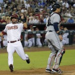Arizona Diamondbacks' David Peralta scores on an RBI base hit by teammate Ender Inciarte as Cleveland Indians catcher Yan Gomes waits for the throw during the second inning of a baseball game, Tuesday, June 24, 2014, in Phoenix. (AP Photo/Matt York)
