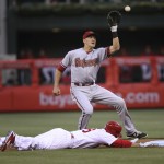 Philadelphia Phillies' Chase Utley (26) is safe at second on a pickoff attempt as Arizona Diamondbacks shortstop Nick Ahmed waits for the throw during the second inning of a baseball game, Friday, May 15, 2015, in Philadelphia. (AP Photo/Laurence Kesterson)