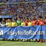 Argentina, left, and Belgium players pose with an anti-racism banner before the World Cup quarterfinal soccer match between Argentina and Belgium at the Estadio Nacional in Brasilia, Brazil, Saturday, July 5, 2014. (AP Photo/Martin Meissner)