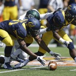 California's Raymond Davison (31) picks up a fumble during the first half of an NCAA college football game against Sacramento State on Saturday, Sept. 6, 2014, in Berkeley, Calif. At right is California's Cameron Walker. (AP Photo/Ben Margot)
