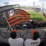 San Francisco Giants fans Jason Strother, left, and Jeremy Strother, wave their Giants flag before Game 4 of baseball's World Series between the Kansas City Royals and the San Francisco Giants on Saturday, Oct. 25, 2014, in San Francisco. (AP Photo/Charlie Riedel)
