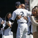  New York Yankees' Derek Jeter (2) embraces his father, Dr. Charles Jeter, during a pregame ceremony honoring the Yankees captain, who is retiring at the end of the season, on Derek Jeter Day at Yankee Stadium in New York, Sunday, Sept. 7, 2014, as Jeter's mother Dorothy, left, and sister Sharlee and her child, right, watch. (AP Photo/Kathy Willens)