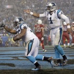 Carolina Panthers' Mike Tolbert, left, and Cam Newton, right, celebrate Tolbert's touchdown against the Arizona Cardinals in the second half of an NFL wild card playoff football game in Charlotte, N.C., Saturday, Jan. 3, 2015. (AP Photo/Bob Leverone)