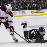  Los Angeles Kings forward Justin Williams (14) falls as Phoenix Coyotes defenseman Oliver Ekman-Larsson (23) steals the puck during the second period of an NHL hockey game, Wednesday, April 2, 2014, in Los Angeles. (AP Photo/Ringo H.W. Chiu)