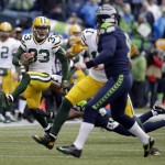 Green Bay Packers' Micah Hyde, left, returns a punt during the first half of the NFL football NFC Championship game against the Seattle Seahawks Sunday, Jan. 18, 2015, in Seattle. (AP Photo/Elaine Thompson)