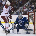 Arizona Coyotes right wing David Moss (18) tries to get a shot past Vancouver Canucks goalie Eddie Lack (31) during the first period of an NHL hockey game Thursday, April 9, 2015, in Vancouver, British Columbia. (AP Photo/The Canadian Press, Jonathan Hayward)