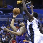 Phoenix Suns' Markieff Morris, left, attempts to shoot over Orlando Magic's Dewayne Dedmon, right, during the first half of an NBA basketball game, Wednesday, March 4, 2015, in Orlando, Fla. (AP Photo/John Raoux)