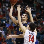 California's David Kravish shoots over Arizona's Dusan Ristic in the first half of an NCAA college basketball game in in the quarterfinals of the Pac-12 conference tournament Thursday, March 12, 2015, in Las Vegas. (AP Photo/John Locher)