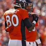 Denver Broncos quarterback Peyton Manning (18) hugs teammate Julius Thomas (80) after throwing his 500th career touchdown pass during the first half of an NFL football game against the Arizona Cardinals, Sunday, Oct. 5, 2014, in Denver. Thomas caught the pass. (AP Photo/Joe Mahoney)