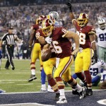 Washington Redskins' Colt McCoy (16) and Roy Helu (29) celebrate a touchdown run by McCoy during the second half of an NFL football game against the Dallas Cowboys, Monday, Oct. 27, 2014, in Arlington, Texas. (AP Photo/Tim Sharp)