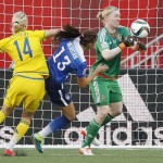 Sweden goalkeeper Hedvig Lindahl (1) saves the header from United States' Alex Morgan (13) as Sweden's Amanda Ilestedt (14) defends during second-half FIFA Women's World Cup soccer game action in Winnipeg, Manitoba, Canada, Friday, June 12, 2015.
