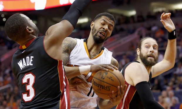 Phoenix Suns’ Markieff Morris (11) pulls down a rebound between Miami Heat’s Dwyane Wad...