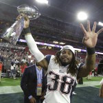 New England Patriots running back Brandon Bolden celebrates with the Vince Lombardi Trophy after the NFL Super Bowl XLIX football game against the Seattle Seahawks Sunday, Feb. 1, 2015, in Glendale, Ariz. The Patriots won 28-24. (AP Photo/Michael Conroy)