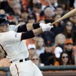 San Francisco Giants' Buster Posey hits a single during the first inning of Game 5 of baseball's World Series against the Kansas City Royals Sunday, Oct. 26, 2014, in San Francisco. (AP Photo/David J. Phillip)