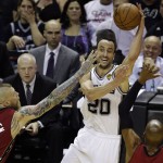 San Antonio Spurs guard Manu Ginobili (20) looks to pass between Miami Heat forward Chris Andersen (11) and guard Ray Allen, right, during the first half in Game 1 of the NBA basketball finals on Thursday, June 5, 2014, in San Antonio. (AP Photo/Tony Gutierrez)