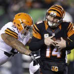  Cincinnati Bengals quarterback Andy Dalton (14) is tackled by Cleveland Browns defensive end Billy Winn (90) during the second half of an NFL football game Thursday, Nov. 6, 2014, in Cincinnati. (AP Photo/Michael Conroy)