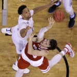 Wisconsin's Frank Kaminsky shoots over Duke's Jahlil Okafor, left, during the first half of the NCAA Final Four college basketball tournament championship game Monday, April 6, 2015, in Indianapolis. (AP Photo/David J. Phillip)