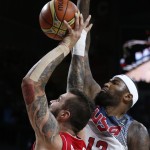 Serbia's Miroslav Raduljica pushes the ball up the basket against United States' DeMarcus Cousins during the final World Basketball match between the United States and Serbia at the Palacio de los Deportes stadium in Madrid, Spain, Sunday, Sept. 14, 2014. (AP Photo/Daniel Ochoa de Olza)
