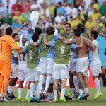 Uruguay players celebrate after the group D World Cup soccer match between Italy and Uruguay at the Arena das Dunas in Natal, Brazil, Tuesday, June 24, 2014. Uruguay edged 10-man Italy 1-0 to reach the second round of the World Cup. (AP Photo/Antonio Calanni)