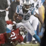 Carolina Panthers' Jerricho Cotchery (82) is tackled by Arizona Cardinals' Antonio Cromartie (31) in the second half of an NFL wild card playoff football game in Charlotte, N.C., Saturday, Jan. 3, 2015. (AP Photo/Bob Leverone)