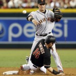 San Francisco Giants second baseman Joe Panik, top, turns the double play while avoiding Arizona Diamondbacks' Chris Owings (16) on a ball hit by Nick Ahmed in the second inning during a baseball game, Saturday, July 18, 2015, in Phoenix. (AP Photo/Rick Scuteri)
