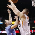 Los Angeles Clippers' J.J. Redick, left, has his shot blocked by Phoenix Suns' Alex Len, right, of Ukraine, during the first half of an NBA basketball game Sunday, Jan. 25, 2015, in Phoenix. (AP Photo/Ross D. Franklin)
