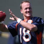 Denver Broncos quarterback Peyton Manning throws football during drills at the morning session of the team's NFL football training camp in Englewood, Colo., on Friday, July 25, 2014. (AP Photo)