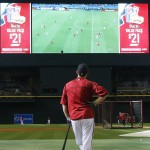 Arizona Diamondbacks' David Peralta watches the World Cup soccer match between the United States and Ghana on the big screen at Chase Field during batting practice prior to a baseball game against the Milwaukee Brewers on Monday, June 16, 2014, in Phoenix. (AP Photo/Ross D. Franklin)