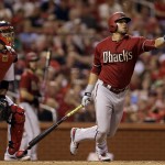 Arizona Diamondbacks' David Peralta, right, and St. Louis Cardinals catcher Yadier Molina watch Peralta's single during the sixth inning of a baseball game Wednesday, May 27, 2015, in St. Louis. St. Louis Cardinals right fielder Jason Heyward was charged with a fielding error and the Diamondbacks scored two runs on the play. (AP Photo/Jeff Roberson)