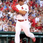 St. Louis Cardinals' Kolten Wong celebrates as he arrives at home after hitting a solo home run during the first inning of a baseball game against the Arizona Diamondbacks Wednesday, May 27, 2015, in St. Louis. (AP Photo/Jeff Roberson)