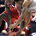 Utah guard Delon Wright, left, fights for the ball with Georgetown guard D'Vauntes Smith-Rivera during the first half of an NCAA college basketball tournament round of 32 game in Portland, Ore., Saturday, March 21, 2015. (AP Photo/Craig Mitchelldyer)
