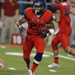 Arizona running back Jared Baker (23) scores a touchdown during the third quarter of an NCAA college football game against Southern California, Saturday, Oct. 11, 2014, in Tucson, Ariz. (AP Photo/Rick Scuteri)