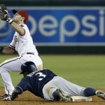 Milwaukee Brewers' Elian Herrera (3) slides into second base with a double as Arizona Diamondbacks' Chris Owings catches a late throw during the ninth inning of a baseball game on Monday, June 16, 2014, in Phoenix. The Brewers defeated the Diamondbacks 9-3. (AP Photo/Ross D. Franklin)
