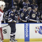 St. Louis Blues' Dmitrij Jaskin (23) celebrates with teammates on the bench, as Arizona Coyotes' Lauri Korpikoski (28) skates back to the bench, after scoring a goal in the second period of an NHL hockey game, Tuesday, Feb. 10, 2015, in St. Louis. (AP Photo/Tom Gannam)
