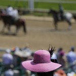 A fan watches a race before the 141st running of the Kentucky Derby horse race at Churchill Downs Saturday, May 2, 2015, in Louisville, Ky. (AP Photo/Jeff Roberson)