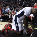 Arizona forward Rondae Hollis-Jefferson rests with his hands on the ball after diving out of bounds after it during an NCAA college basketball tournament round of 32 game against Ohio State in Portland, Ore., Saturday, March 21, 2015. (AP Photo/Craig Mitchelldyer)