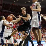 Gonzaga guard Kevin Pangos (4) looks to pass in front of Arizona forward Brandon Ashley (21) during the first half of an NCAA college basketball game, Saturday, Dec. 6, 2014, in Tucson, Ariz. (AP Photo/Rick Scuteri)