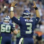 Seattle Seahawks quarterback Russell Wilson (3) celebrates as Marshawn Lynch runs for a touchdown during the first half of NFL Super Bowl XLIX football game against the New England Patriots Sunday, Feb. 1, 2015, in Glendale, Ariz. (AP Photo/Michael Conroy)