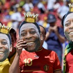 Belgium soccer team supporters hold up masks of Brazilan soccer legend Pele before the World Cup quarterfinal soccer match between Argentina and Belgium at the Estadio Nacional in Brasilia, Brazil, Saturday, July 5, 2014. (AP Photo/Martin Meissner)