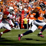 Denver Broncos wide receiver Demaryius Thomas (88) runs in a touchdown as Arizona Cardinals free safety Rashad Johnson defends during the first half of an NFL football game, Sunday, Oct. 5, 2014, in Denver. (AP Photo/Jack Dempsey)